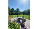 Backyard featuring a fire pit area with seating and lush greenery at 2104 Farmbrook Dr, Statesville, NC 28625