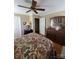 Bedroom featuring ceiling fan, closet, dresser, and floral patterned bedding at 2104 Farmbrook Dr, Statesville, NC 28625