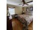 Bedroom with hardwood floors, ceiling fan, and floral patterned bedding at 2104 Farmbrook Dr, Statesville, NC 28625