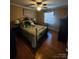 Comfortable bedroom featuring hardwood floors, a ceiling fan, and a large window at 2104 Farmbrook Dr, Statesville, NC 28625