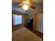 Well-lit bedroom with hardwood floors, a dresser, and a ceiling fan at 2104 Farmbrook Dr, Statesville, NC 28625