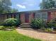 Charming brick home with updated landscaping and a paved walkway leading to the front entrance at 2104 Farmbrook Dr, Statesville, NC 28625