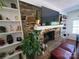 Inviting living room fireplace with stone surround, mantel, and built-in shelving at 2104 Farmbrook Dr, Statesville, NC 28625