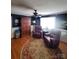 Comfortable living area with two recliners, hardwood floors, and a ceiling fan at 2104 Farmbrook Dr, Statesville, NC 28625