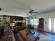 Cozy living room featuring a stone fireplace, built-in shelving, and hardwood floors at 2104 Farmbrook Dr, Statesville, NC 28625