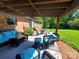 Charming covered patio featuring outdoor seating and a lush green backyard view at 2104 Farmbrook Dr, Statesville, NC 28625