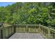 Relaxing back deck overlooking the wooded backyard with lush, mature trees at 218 Water Oak Dr, Pineville, NC 28134