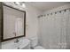 Clean bathroom with classic mirror, lighting, and a shower with a curtain at 218 Water Oak Dr, Pineville, NC 28134