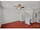 Bedroom with hardwood floors, ceiling fan, and an ensuite bath with a vanity at 218 Water Oak Dr, Pineville, NC 28134