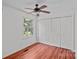 Bright bedroom with hardwood floors, ceiling fan, and a large closet at 218 Water Oak Dr, Pineville, NC 28134