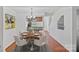 Inviting dining area with a modern chandelier and hardwood floors with a round table at 218 Water Oak Dr, Pineville, NC 28134