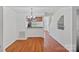 Inviting dining area with a modern chandelier and hardwood floors that connects to the kitchen at 218 Water Oak Dr, Pineville, NC 28134