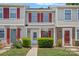 Charming townhome with a well-manicured front yard and inviting entrance. Features red shutters at 218 Water Oak Dr, Pineville, NC 28134