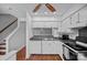 Functional kitchen with white cabinetry, grey countertops, hardwood floors, and a stainless-steel sink at 218 Water Oak Dr, Pineville, NC 28134