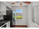 Cozy kitchen featuring a black refrigerator and bright window with a view to the outdoors at 218 Water Oak Dr, Pineville, NC 28134