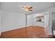 Spacious living room with hardwood floors and lots of natural light that connects to the dining and kitchen area at 218 Water Oak Dr, Pineville, NC 28134