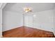 Bright living room features hardwood floors, ceiling fan, and access to a sliding glass door at 218 Water Oak Dr, Pineville, NC 28134