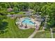 Aerial view of a sparkling community pool with ample lounge chairs and manicured grounds at 218 Water Oak Dr, Pineville, NC 28134