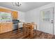 Cozy eat-in kitchen with natural wood cabinets, stainless steel appliances, and adjacent dining area at 23 Redwood Ct, Alexander, NC 28601