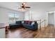 Bright living room featuring a large window, cozy sectional sofa, and modern ceiling fan with lighting at 23 Redwood Ct, Alexander, NC 28601