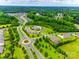Aerial view showcasing the community, pool, clubhouse, and lush green spaces at 2324 Loire Valley Dr, Indian Land, SC 29707