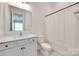 Clean bathroom featuring a white vanity, toilet, and shower with a white curtain at 2324 Loire Valley Dr, Indian Land, SC 29707