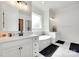 Bright bathroom with double vanities, a soaking tub under a window, and modern fixtures at 2324 Loire Valley Dr, Indian Land, SC 29707