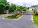 A gated community entrance with stone pillars and manicured landscaping, offering an exclusive living experience at 2324 Loire Valley Dr, Indian Land, SC 29707