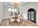 Elegant dining room with a round table, stylish chairs, and decorative lighting fixture at 2324 Loire Valley Dr, Indian Land, SC 29707
