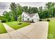 Stunning two-story home showcasing a manicured lawn, elegant driveway and three-car garage at 2324 Loire Valley Dr, Indian Land, SC 29707