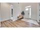 Bright foyer with hardwood floors, wainscoting, and a bench beneath a transom window at 2324 Loire Valley Dr, Indian Land, SC 29707