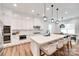 Well-lit kitchen with an island and barstools, built-in oven, stainless steel appliances, and a dining area at 2324 Loire Valley Dr, Indian Land, SC 29707