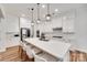 Bright kitchen featuring white cabinets, stainless steel appliances, and a large center island with seating for three at 2324 Loire Valley Dr, Indian Land, SC 29707