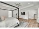 Spacious main bedroom featuring a four-poster bed, ceiling fan, and ensuite bathroom with wood-look flooring at 2324 Loire Valley Dr, Indian Land, SC 29707