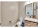Stylish powder room with modern vanity, rectangle mirror and neutral color scheme at 2324 Loire Valley Dr, Indian Land, SC 29707