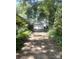 Backyard view with a detached garage, mature trees, and a long driveway, offering ample space at 237 Institute St, Mooresville, NC 28115