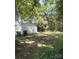 View of backyard shed with mature trees and greenery, offering ample storage space at 237 Institute St, Mooresville, NC 28115