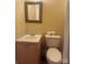 Modest bathroom featuring a toilet, sink and mirror at 237 Institute St, Mooresville, NC 28115