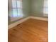 Bright bedroom features windows and original hardwood floors offering a cozy retreat at 237 Institute St, Mooresville, NC 28115