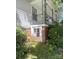 Exterior detail highlighting a brick foundation and lush landscaping, adding character and charm to the home at 237 Institute St, Mooresville, NC 28115