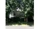 Quaint home with a covered front porch framed by mature trees, offering shade and curb appeal at 237 Institute St, Mooresville, NC 28115