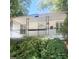 Inviting front porch featuring a decorative railing and white siding, complemented by lush greenery at 237 Institute St, Mooresville, NC 28115