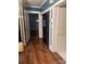 Entryway with view to living room, featuring wood look flooring at 237 Institute St, Mooresville, NC 28115