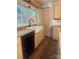 Close up on the kitchen's farmhouse sink, stainless steel dishwasher, and light wood cabinets at 237 Institute St, Mooresville, NC 28115
