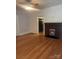 Cozy living room features original hardwood floors and fireplace adding warmth to the space at 237 Institute St, Mooresville, NC 28115
