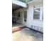 The side porch features a brick step, leading to an outside sitting area with a white chair at 237 Institute St, Mooresville, NC 28115