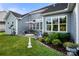 Backyard patio with beautiful landscaping, outdoor seating, and lush green lawn at 2399 Ashbourne Se Pl, Concord, NC 28025