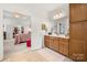 Open bathroom with double sink vanity, and decorative lighting fixtures at 2399 Ashbourne Se Pl, Concord, NC 28025