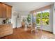 Bright breakfast nook with large windows, hardwood floors, chandelier, and seating for four at 2399 Ashbourne Se Pl, Concord, NC 28025