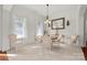 Bright dining room with a neutral paint, decorative mirror, and ample natural light at 2399 Ashbourne Se Pl, Concord, NC 28025